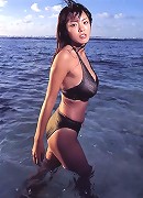 Alluring asian beauty with large heavy breasts in a bikini