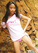 Really tiny Thai teen poses in cute outfit on the seaside rocks