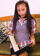 Thainee looking very innocent in a school girl dress